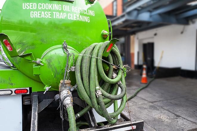 grease trap pumping truck servicing a restaurant in Greenbrier